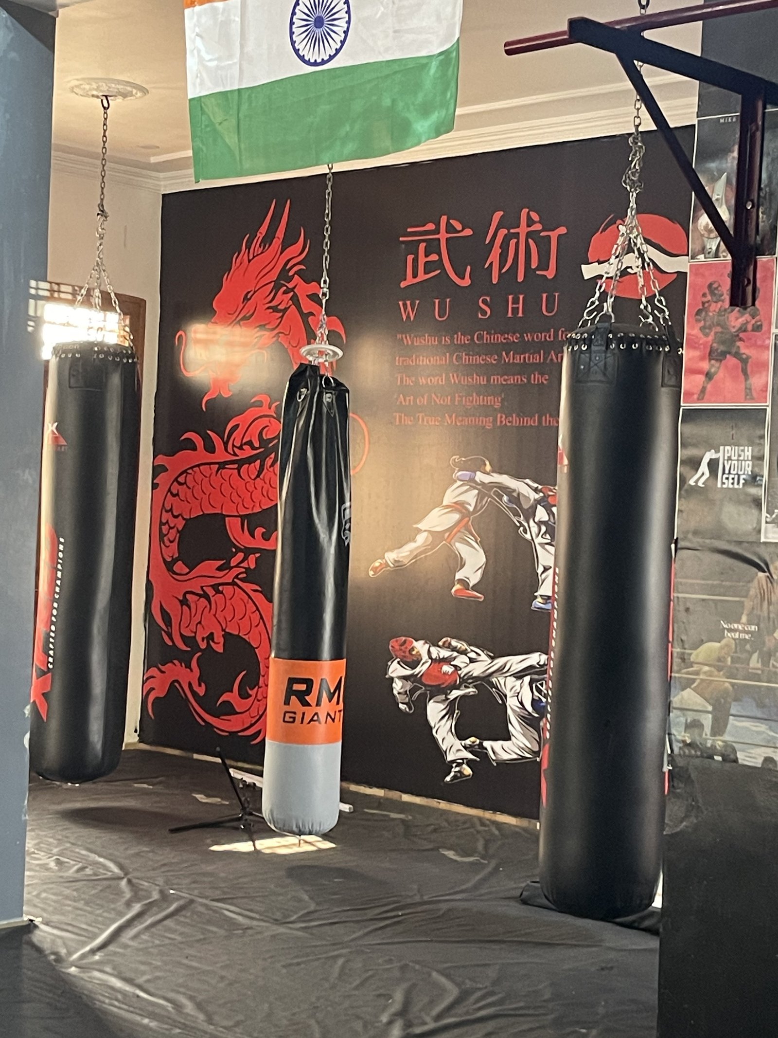 MMA training bags hanging inside Yoddha Combat Club interior